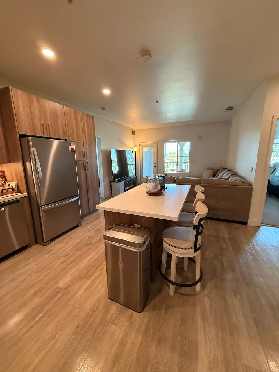 Open apartment kitchen and living area with a quartz island