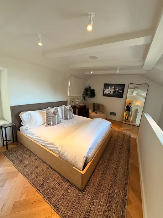 Loft bedroom with a beamed ceiling