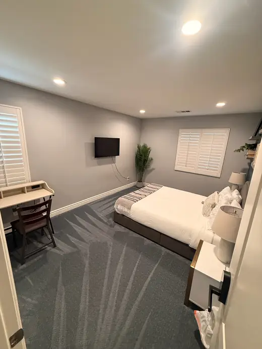 Cleaned blue-gray carpet in a furnished bedroom