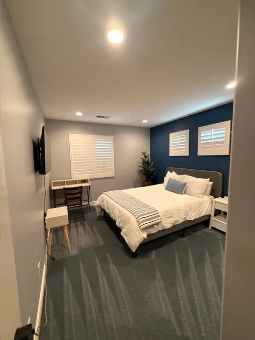 Cleaned carpet in a furnished bedroom with a desk