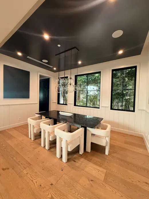 Dining room with a black ceiling and wood floors