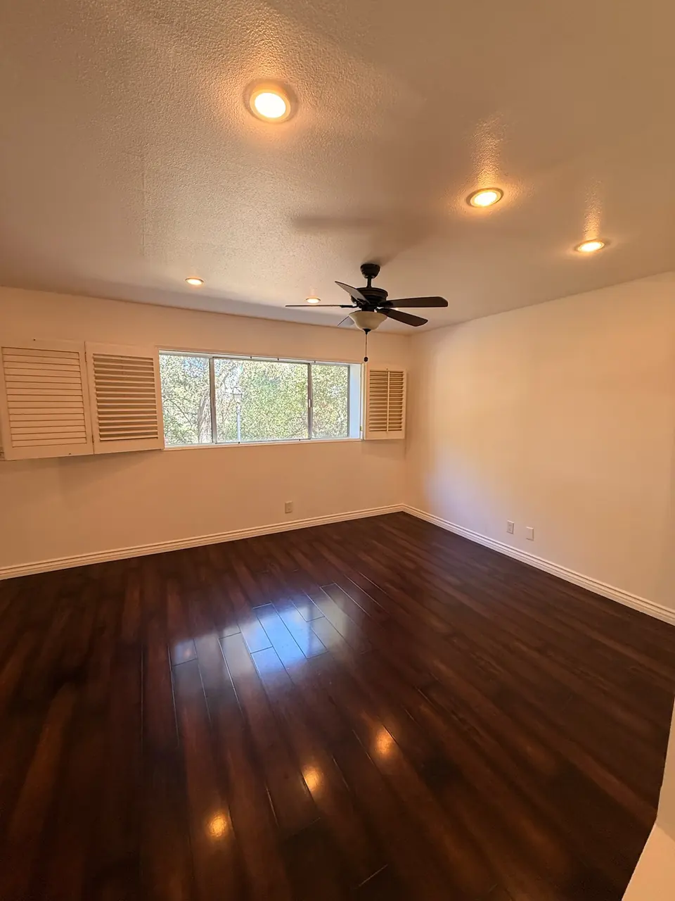 Empty room with polished dark hardwood floors