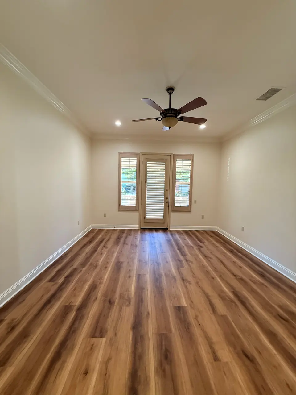 Empty room with crown molding and clean floors