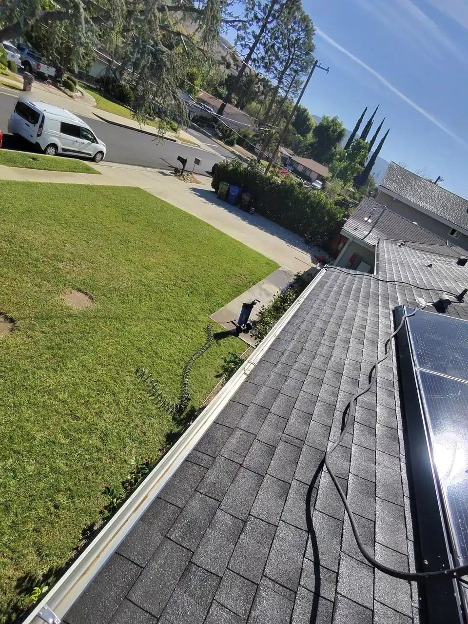 Clean gutter running the length of a shingle roof