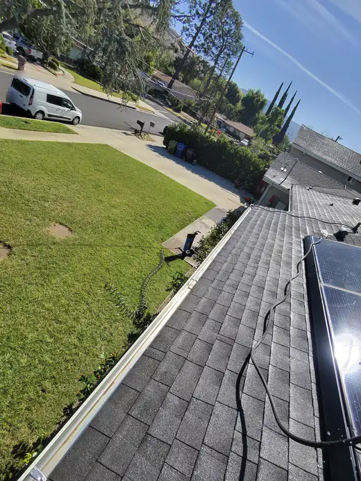 Clean gutter running the length of a shingle roof