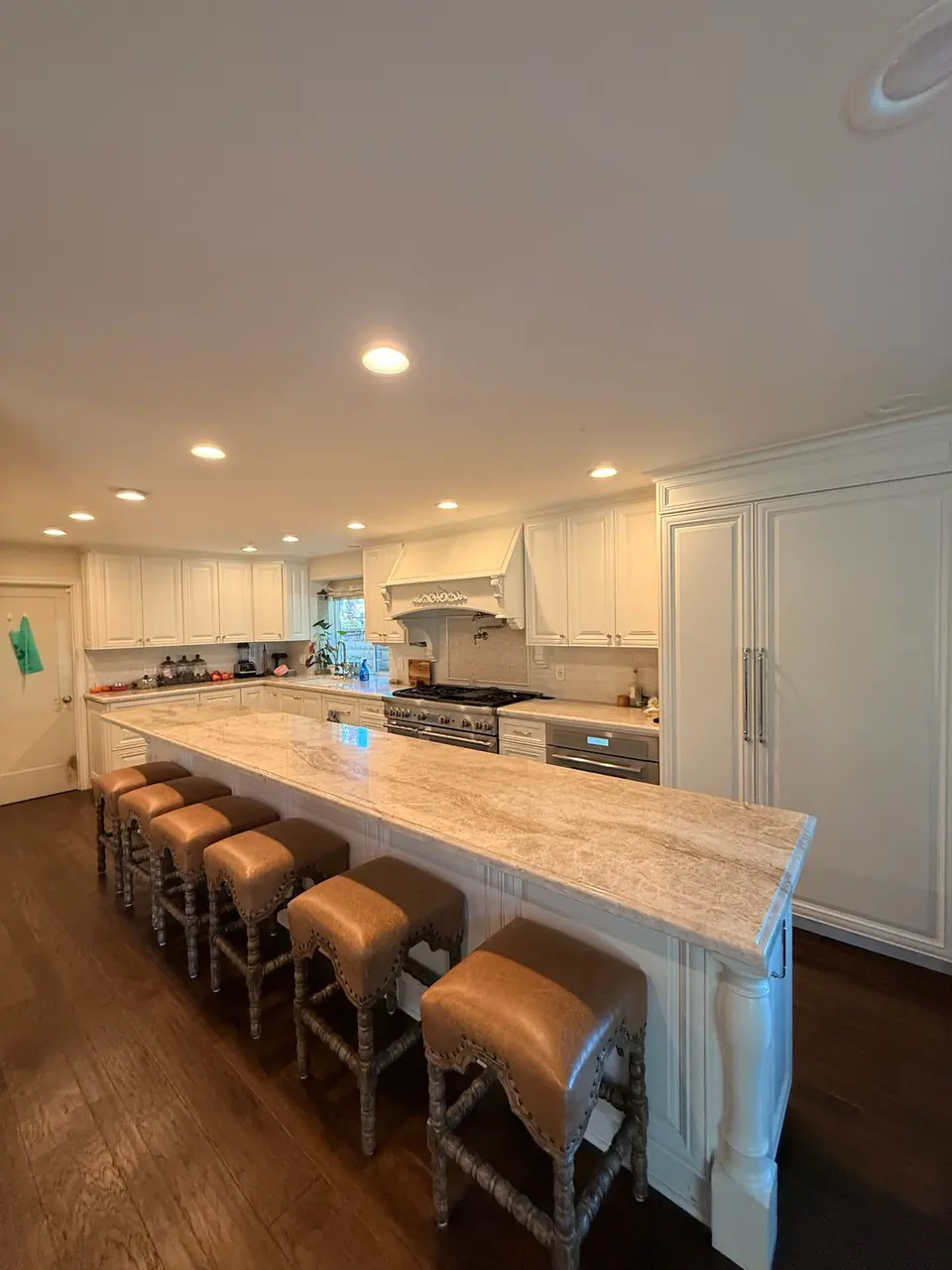 Large kitchen with a long marble island