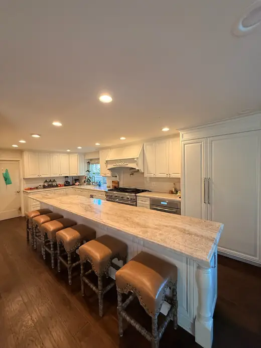 Large kitchen with a long marble island