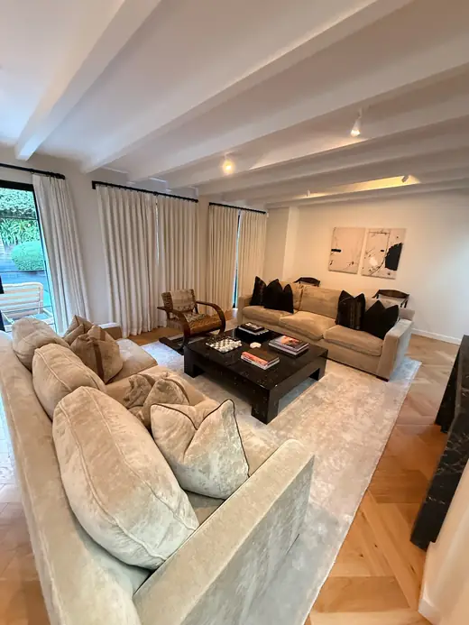 Living room with sofas and a beamed ceiling