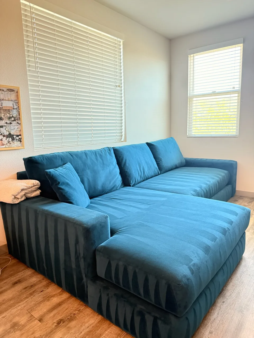 Teal velvet sectional sofa with clean pass marks on the cushions