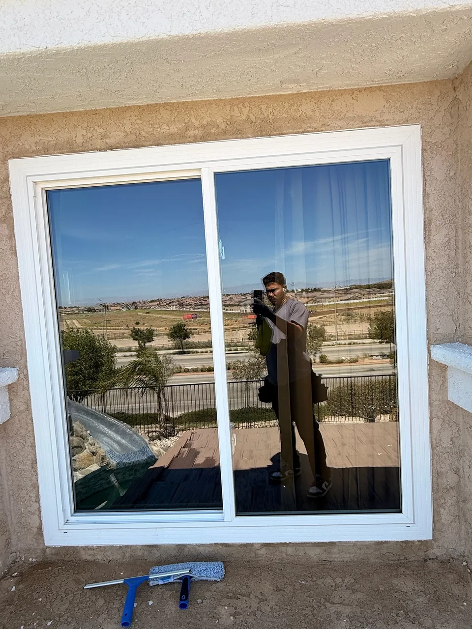 Freshly cleaned sliding window with a view of the hills