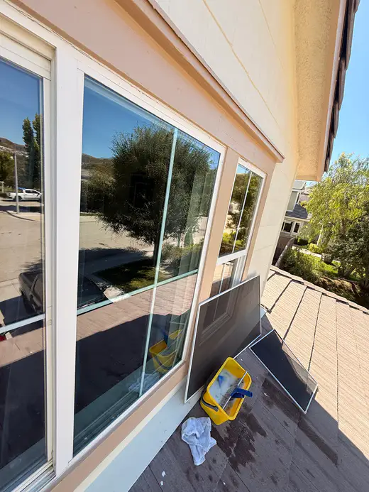 Second-story windows cleaned, with the screens set aside on the roof